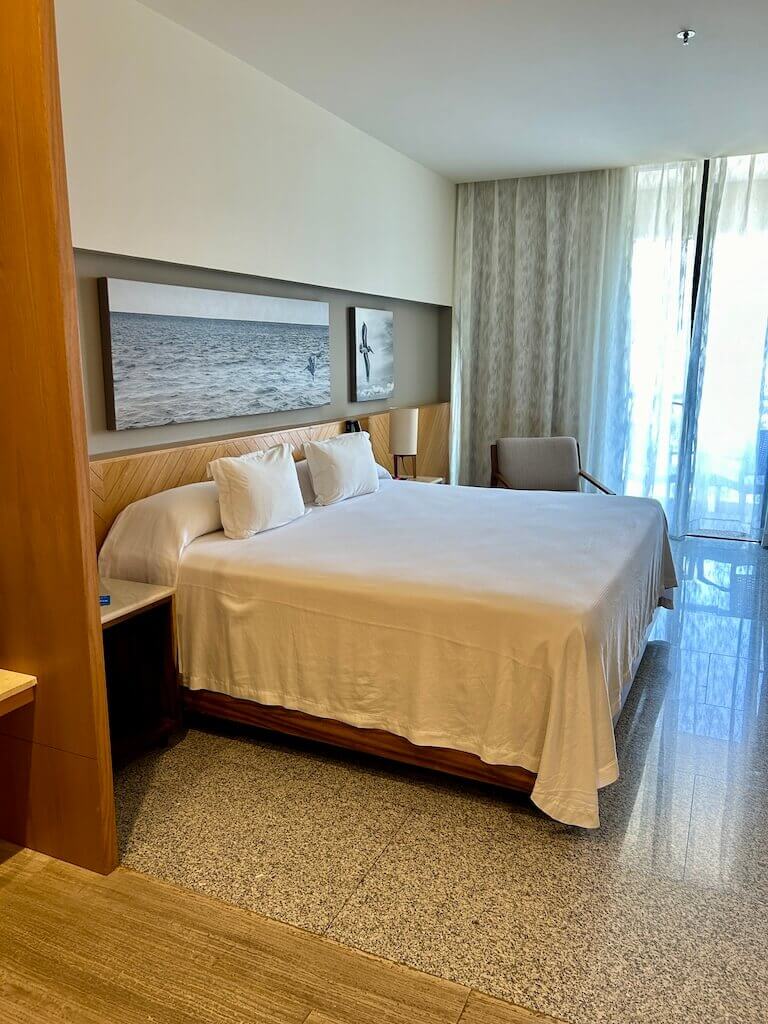 king bed in a spacious hotel room